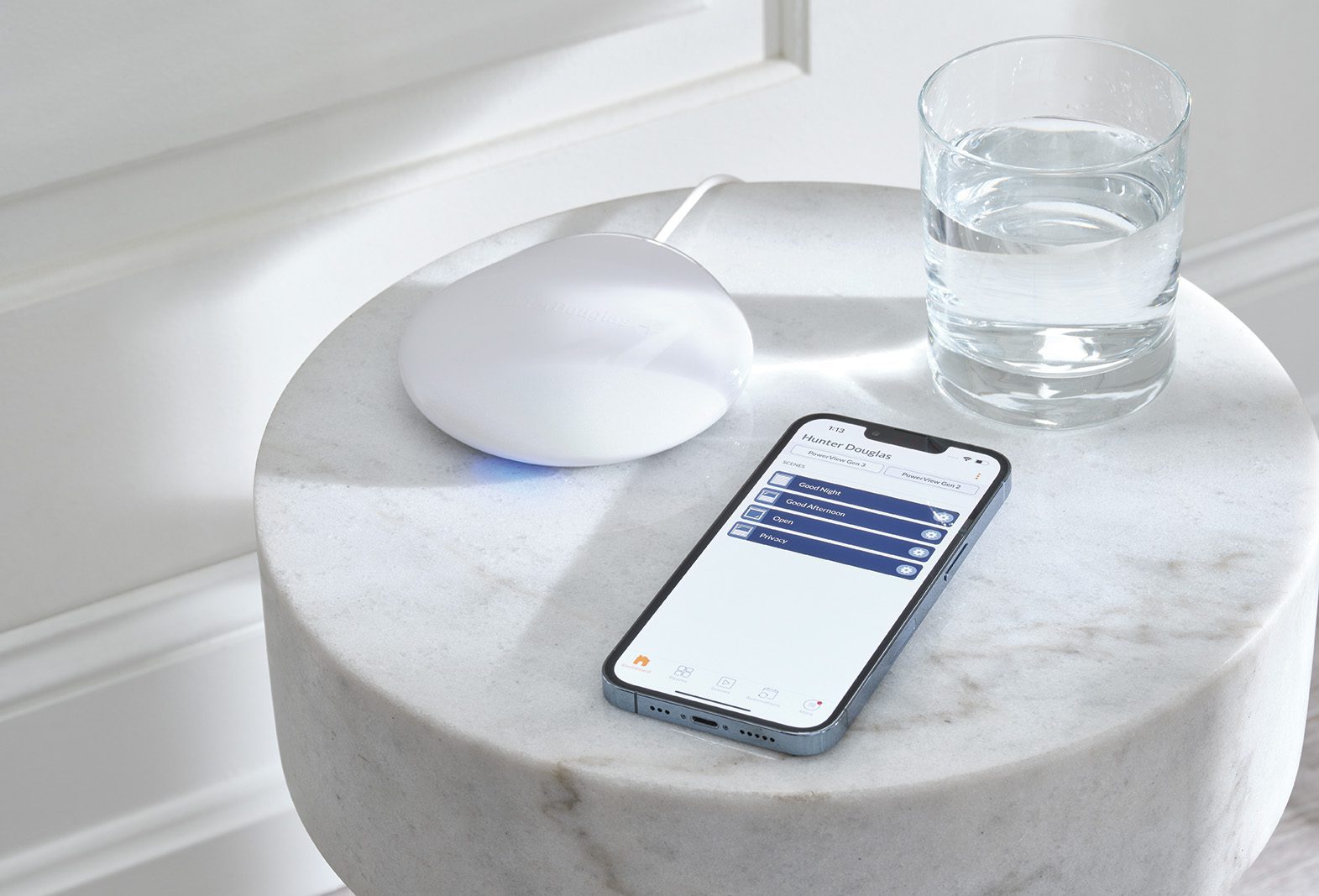 Hunter Douglas PowerView Gateway next to Iphone with Hunter Douglas PowerView Automation App